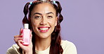 Face, skincare and happy woman with cosmetics bottle, facial cleanser or moisturizer. Portrait, beauty product and model with container for toner, dermatology and purple background space in studio