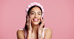 Happy woman, face and beauty with lotion in studio for skincare cosmetics on a pink background. Portrait, female person or smile with facial massage or cream for moisturizer, glow or shine on space