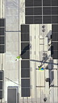 Drone, architecture and people on rooftop, solar panels or property development with sustainability. Outdoor, group and colleagues with renewable energy, aerial view and civil engineering in city