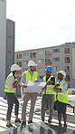 City, architecture and people with blueprint, talking and property development with renewable energy. Outdoor, solar panels and group on roof with floor plans, sustainable power and civil engineering