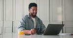 Credit card, laptop and online shopping with man in home kitchen for consumerism or payment. Computer, ecommerce and purchase with happy customer in apartment for bank transfer or transaction