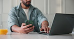 Man, hands and phone with laptop in home for online research, network or app connection. Male person, freelancer or remote work with mobile smartphone or computer for schedule planning in kitchen