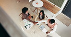 Business people, team and meeting with hands together in cafe for unity, trust or mission. Top view, group or employees with pile, stack or documents in solidarity for performance in coffee shop