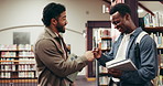 Men, college student and friends at library with fist bump, greeting and happy at academy. People, reunion and hello with books, education and discussion for learning with scholarship at university