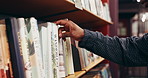 Choosing, books and hands of man in library at university for research, learning or knowledge. Education, college project and male student with decision on academic information by shelf on campus.
