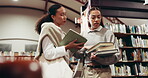 Tablet, women or talking in library with books for college, language course or studying literature. Tech, student or people in bookshop with discussion for textbook, reading or university assignment.