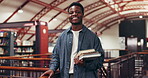 College, face and man with books in library for thesis research, test preparation or study material. Education, black person and happy with textbooks at university for learning or academic resources