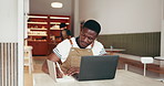 African man, stretching or writing in restaurant with laptop, research or review for company website. Online, manager or people in cafe with tech, tired or investigation for customer insights.