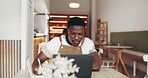 Business, African man or writing in restaurant with laptop, research or review for company website. Online, manager or people in cafe with tech, strategy or investigation for customer insights