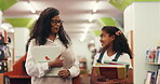 Teacher, child and walking with books in library for tutoring appointment, learning support and chat. Education, tutor and student with conversation at school for test preparation and lesson feedback