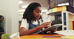 Girl, child and tablet at library for homework, research and typing for elearning project at school. Kid, tech and pupil on application, notes or solution with online course for education at academy