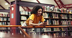 Happy woman, student and typing with phone in library for research, ebook or social media. Female person, bookstore and smile with mobile smartphone for knowledge, study or online app in book shop
