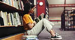 Reading, book and woman with headphones, library and assignment preparation with literature or info. Learning, university student and person with tech to block distractions, education and knowledge