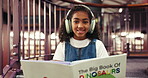 Library, face and child with headphones, book and happy to learn with literature, education or study. Student, smile and girl with noise canceling tech to block distractions, growth and knowledge