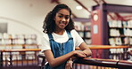 Face, child and student with smile in library for education, studying and story for knowledge. Portrait, kid and girl with happiness for novel search, fantasy books and scholarship of learning growth