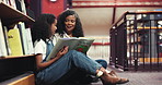 Book, library and grandma reading with kid for bonding, connection or development. Happy, education and senior woman with girl child for story together on stairs for knowledge and literature learning