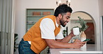 Coffee, laugh and man in kitchen with phone, typing and social media or internet and texting. Reading, person and warm beverage with communication, joke or message for online dating or chatting