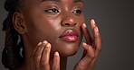 Black woman, check and patch for skincare in studio for pimple breakout, acne treatment and healing. Person, touch and cosmetics of spot inspection, blemish removal and oil control on dark background