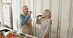Romance, toast or senior couple in kitchen with drinks, communication and bonding in cooking together. Happiness, mature man and woman in house with alcohol, cheers and connection in home recipe.