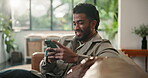 Break, phone and smile with man on sofa in living room of home for relax or social media browsing. App, text message and typing with person in apartment for communication, me time or text message