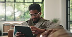 Relax, reading and tablet with man on sofa for streaming service notification and typing. Movie subscription search, online film and media app with person in living room of home for download