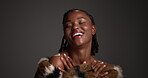 Skincare, face and black woman in studio with coat, designer or luxury cosmetics in body product. Smile, glow or female person on gray background with confidence, glamour or trendy in modern beauty.