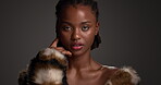 Attitude, face and luxury skincare with black woman in studio for cosmetics or dermatology. Aesthetic, beauty and fur coat with glamour model on dark background for cosmetology or transformation
