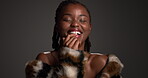 Skincare, face or black woman in studio with smile, designer or luxury cosmetic in body product. Confidence, glow or female person on gray background with fur coat, glamour or trendy in modern beauty