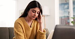 Anxiety, laptop and stress with woman on sofa in living room of home for budget or finance. Computer, frustration and headache with Indian person in apartment for investment or savings mistake