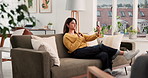 Phone, relax and video call with woman on sofa in living room of home for chat or conversation. Break, communication and wave with happy Indian person in apartment on weekend for connectivity