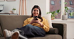 Laughing, woman and relax with smartphone, lounge and watching funny video on social media or online. Happy, person and streaming with mobile app, comfortable and entertainment on website in house