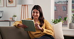Laughing, woman and relax with tablet, home and browsing website for entertainment, ebook and online. Scroll, app and person with tech for funny story, humor and chill in house, reading or literature