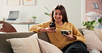 Happy woman, phone and coffee on sofa with texting, funny chat and relax with online dating in lounge. Person, smartphone and tea cup with contact, mobile app and smile with social media at apartment