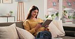 Coffee, reading and woman with book on sofa to relax, rest and comfortable with hobby in home. Laugh, living room and person with novel, story and literature for learning, entertainment and fiction
