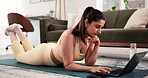 Fitness blogger, home and woman with laptop, typing and content creation on social media or website. Online, influencer and person with tech for workout article, editing and proofreading on floor