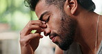 Headache, regret or stress with man in home living room for contemplation of error, failure or mistake. Anxiety, depression or frustration with unhappy person in apartment for migraine or pressure