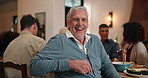 Face, funny and thanksgiving with old man in dining room for family gathering or social event. Celebration, holiday and tradition with person laughing at table in apartment for dinner party or feast