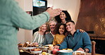 Family, happy and photograph at house with food for celebration, holiday and direction. Child, interracial people and grandparents together for picture, lunch and smile for belonging, memory or home