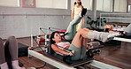 Pilates, reformer and woman in studio, fitness and support with routine, wellness and exercise. People, trainer and instruction with workout, health or machine with challenge, resistance or equipment