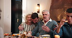 Love, social gathering and thanksgiving with family hugging in dining room together for celebration. Bonding, food and man son hugging mature parents in apartment for greeting, holidays or support