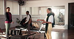 Fitness trainer, women or set up with pilates equipment in gym for class, workout or exercise preparation. Getting ready, people or coach with reformer machine in studio, instruction or communication