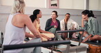 Discussion, class and women in gym with reformer, conversation or bonding together in fitness goals. Support, connection or female people in studio with motivation, team or talking in group activity.