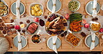 Chicken, table setting and thanksgiving in dining room of home for feast or roast dinner from above. Food, meal and spread with cuisine in apartment for celebration, holiday tradition or season