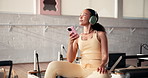 Woman, headphones and phone at pilates class for exercise, singing and reflection at gym. Person, smile and listen to music with smartphone, mobile app and subscription for training at fitness studio
