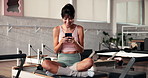 Cellphone, fitness and woman in gym for pilates with networking, social media or communication. Happy, health and female person with phone for contact or connectivity on mobile app in yoga studio.