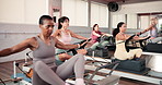 Women, pilates and reformer machine in class for fitness, strength training and arm workout. People, resistance equipment and mobility exercise for wellness, improve posture and flexibility in centre