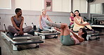 Pilates, class or women in studio with stretching, mobility or balance improvement in body wellness. Support, spinal workout or instructor in club with reformer, muscle or core tone in group exercise