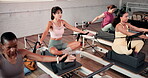 Exercise, people and pilates machine in studio, arm workout and improve core strength in group class. Fitness, resilience and women with reformer in health club for training, flexibility and wellness