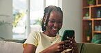 Phone, smile and typing with black woman on sofa in living room of home for post or update. App, browsing and social media with happy African person in apartment for break, communication or me time