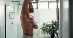 Man, shirtless and spray deodorant in bathroom for hygiene, smell fresh and grooming for odor control. Person, mirror and product for underarm fragrance, body cosmetics and sweat prevention at house